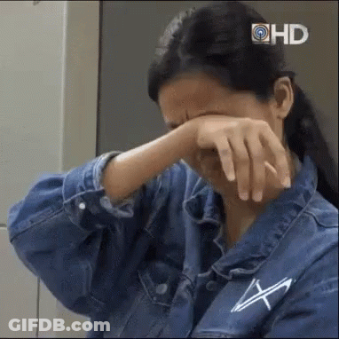 Woman In Denim Jacket Covering Face GIF