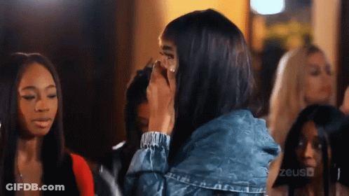 Woman In Denim Jacket Covering Face GIF