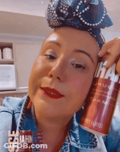 Woman In Denim Jacket Holding Can GIF