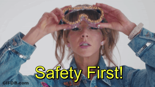 Woman In Denim Jacket Holding Goggles Saying Safety First GIF
