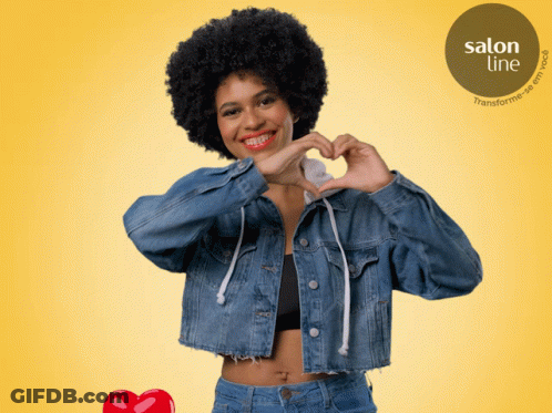 Woman In Denim Jacket Making Heart Shape GIF