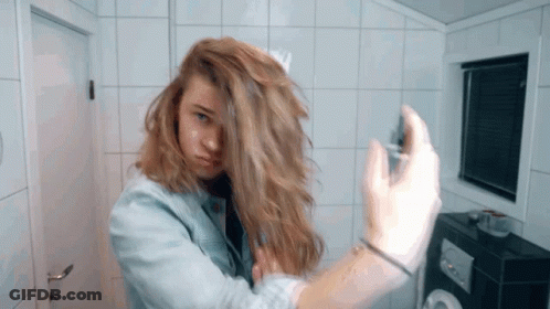 Woman In Denim Jacket Spraying Hair GIF
