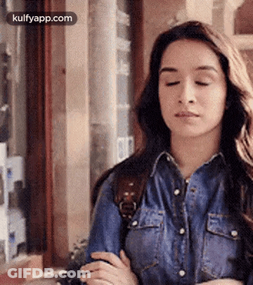 Woman In Denim Shirt With Eyes Closed GIF