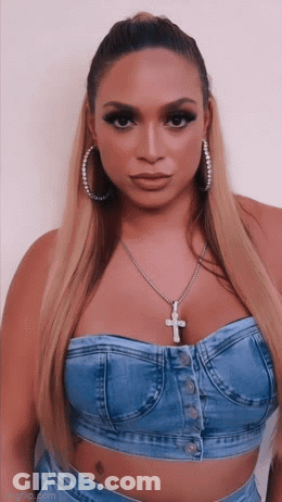 Woman In Denim Top And Cross Necklace GIF
