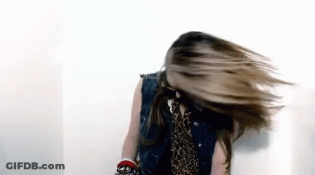 Woman In Denim Vest And Leopard Print Shirt Spinning Hair GIF