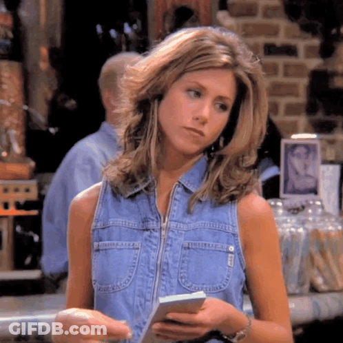 Woman In Denim Vest Holding Paper GIF