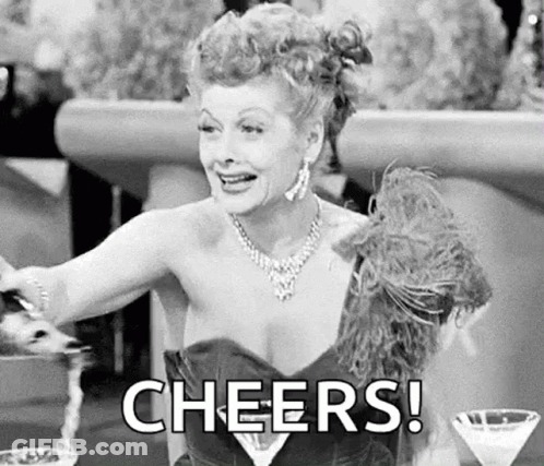 Woman In Dress Cheers With Martini GIF