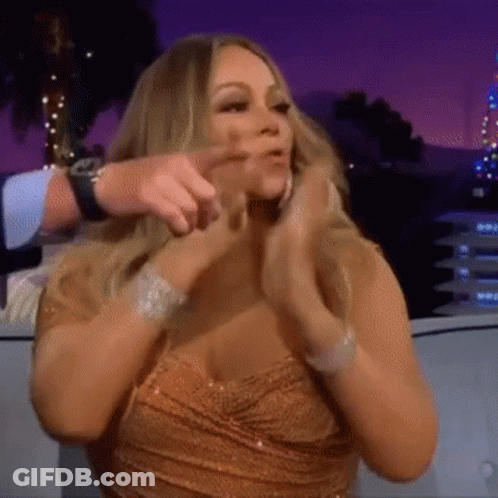 Woman In Dress Clapping While Sitting On Couch GIF