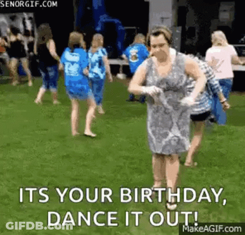 Woman In Dress Dancing In Field With Group GIF