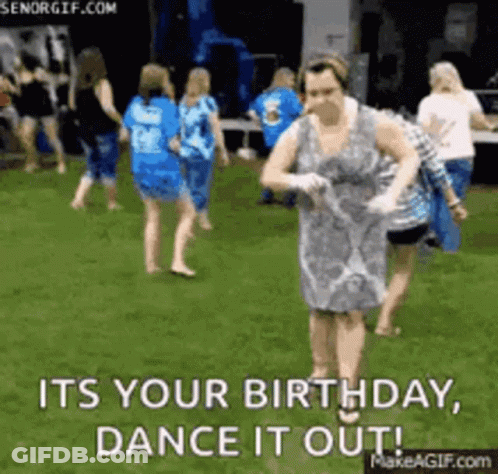 Woman In Dress Dancing In Grass While Group Watches GIF