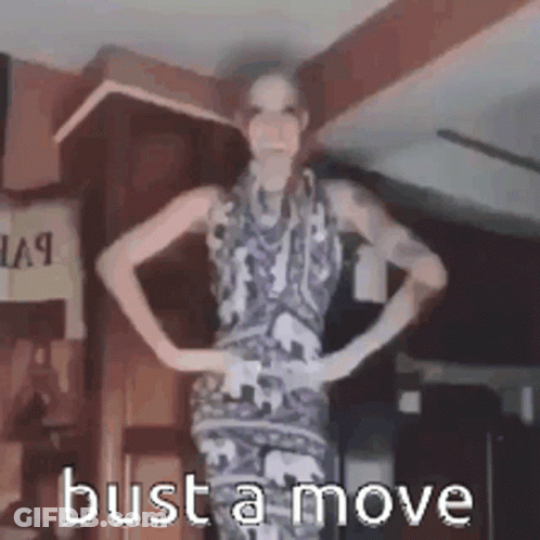 Woman In Dress Hands On Hips Says Bust A Move GIF
