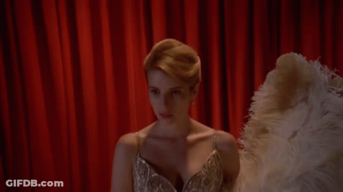 Woman In Dress Holding Ostrich Feather Fan GIF