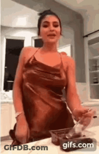 Woman In Dress Holding Spoon GIF