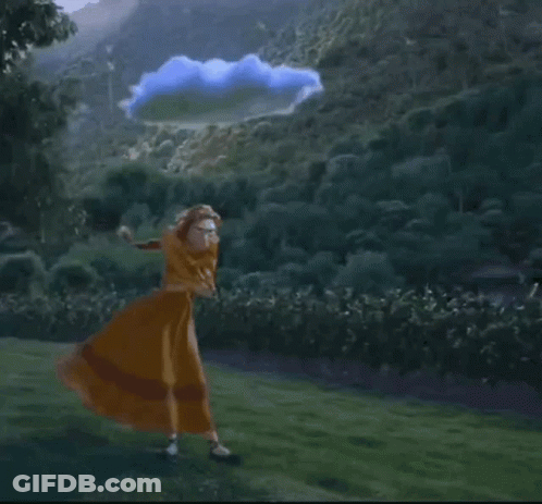 Woman In Dress Holding Yellow Umbrella In Field GIF