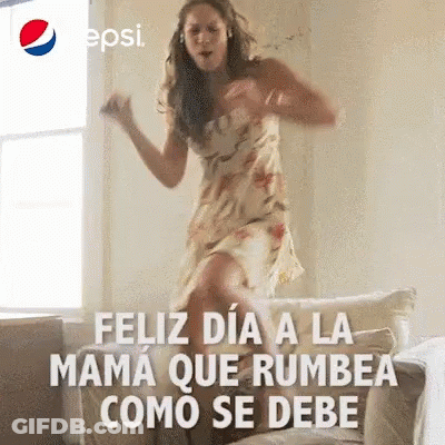Woman In Dress Jumping And Dancing On Couch GIF