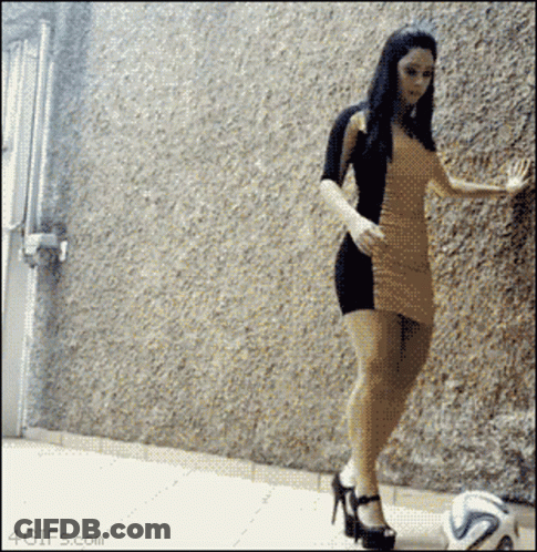 Woman In Dress Kicking Soccer Ball GIF