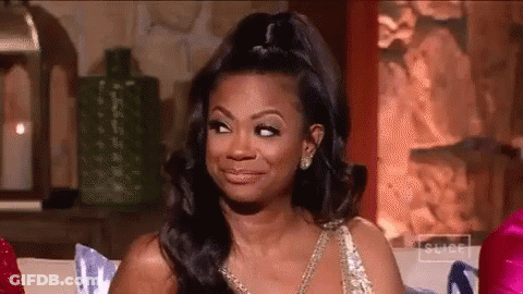 Woman In Dress Making Face On Couch GIF