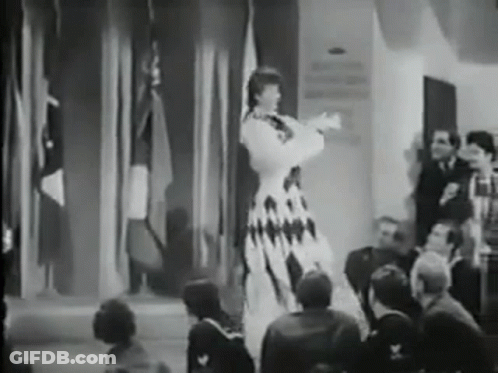 Woman In Dress On Stage GIF
