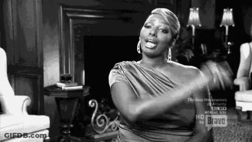 Woman In Dress Sitting In Living Room GIF