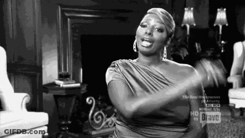 Woman In Dress Sitting With Hands In Air GIF