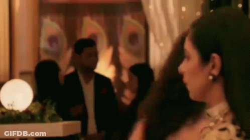 Woman In Dress Standing With Man In Suit GIF