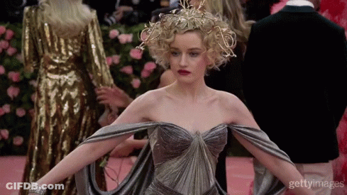 Woman In Dress With Crown On Pink Carpet GIF