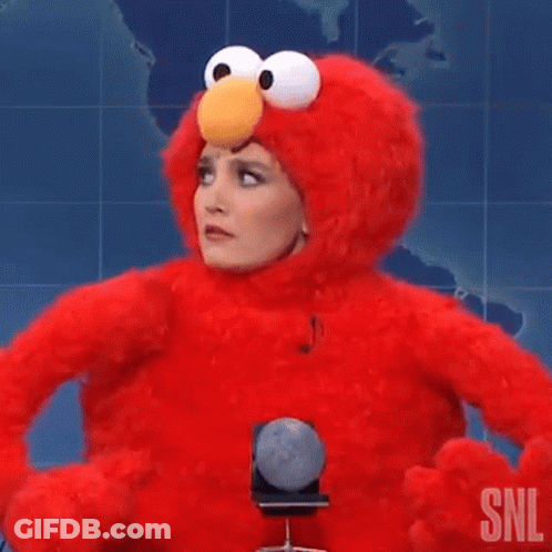Woman In Elmo Costume Holding Microphone Making Funny Face GIF