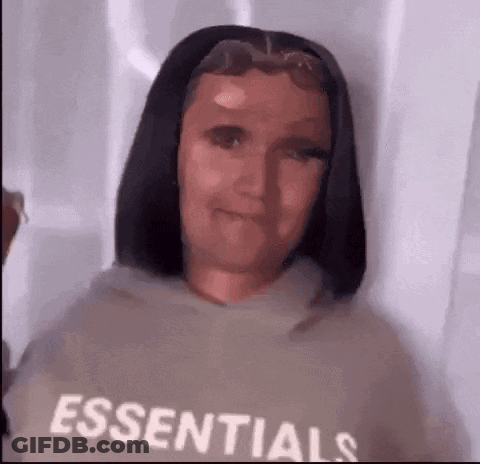 Woman In Essentials Hoodie Looking At Camera GIF