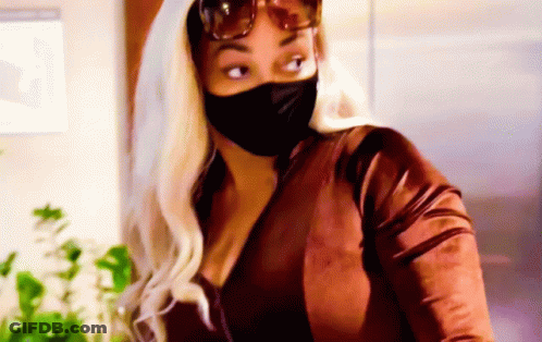 Woman In Face Mask And Sunglasses In Kitchen GIF