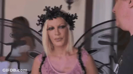 Woman In Fairy Costume Talking To Man In Black Shirt GIF