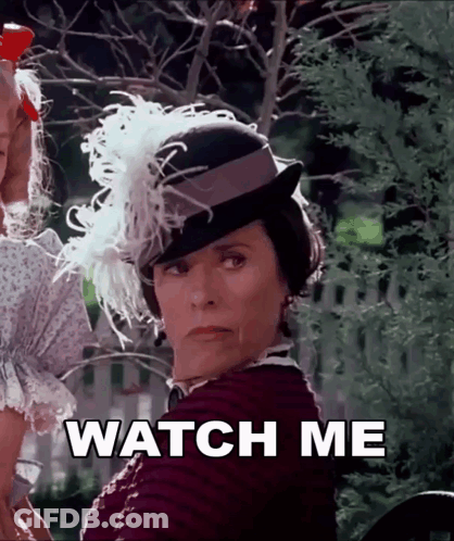 Woman In Feathered Hat Saying Watch Me GIF