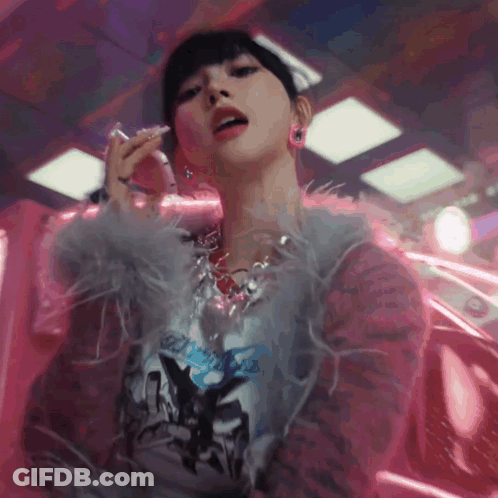 Woman In Feathered Jacket And Necklace Smoking Cigarette GIF
