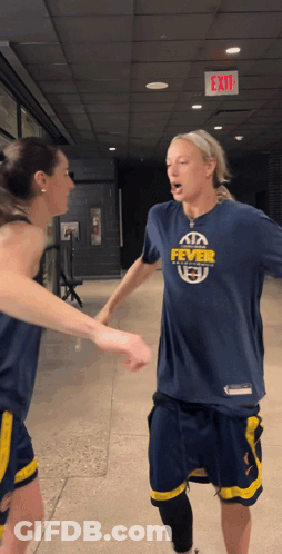 Woman In Fever Shirt Shaking Hands GIF