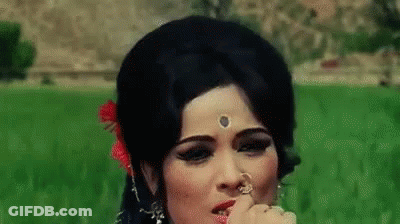 Woman In Field With Flower In Hair And Nose Ring GIF