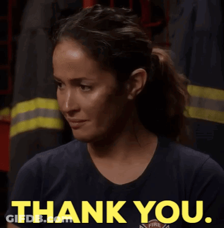 Woman In Firefighter Uniform Giving Thank You Sign GIF