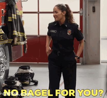 Woman In Firefighter Uniform In Front Of Fire Truck GIF