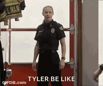Woman In Firefighter Uniform In Front Of Fire Truck GIF