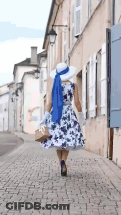 Woman In Floral Dress And White Hat Walking GIF