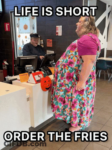 Woman In Floral Dress At McDonald's Counter Saying Life Is Short GIF