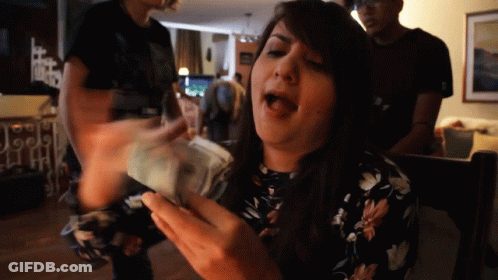 Woman In Floral Dress Holding Money GIF