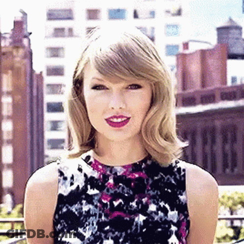 Woman In Floral Dress In Front Of City Skyline GIF