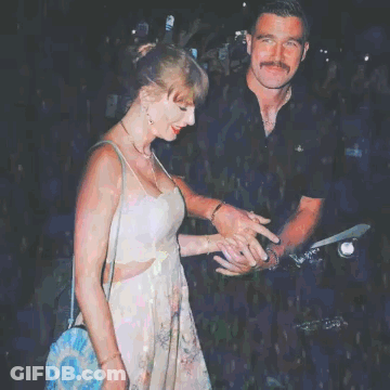 Woman In Floral Dress Next To Man In Black Shirt GIF