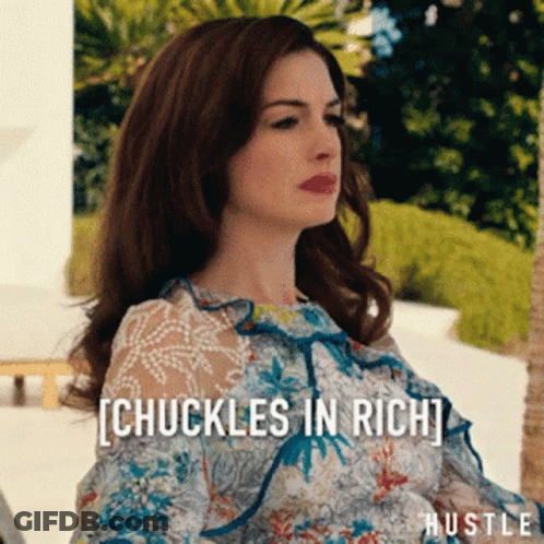 Woman In Floral Dress Sitting In Front Of Chuckles In Rich Sign GIF