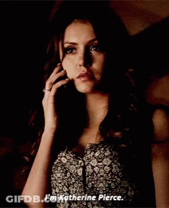 Woman In Floral Dress Talking On Cell Phone Says I'm Katherine Pierce GIF