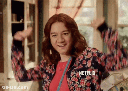 Woman In Floral Jacket Arms In Air GIF