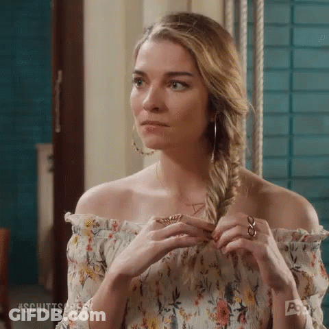 Woman In Floral Off-Shoulder Top Braiding Hair GIF
