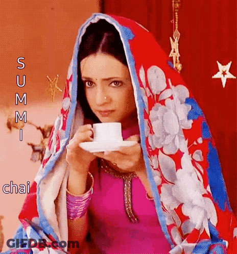 Woman In Floral Scarf Drinking Tea GIF