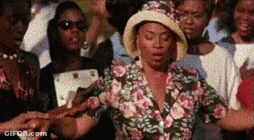 Woman In Floral Shirt And Hat GIF