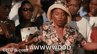 Woman In Floral Shirt And Hat Standing In Crowd GIF