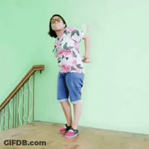 Woman In Floral Shirt Doing Handstand GIF